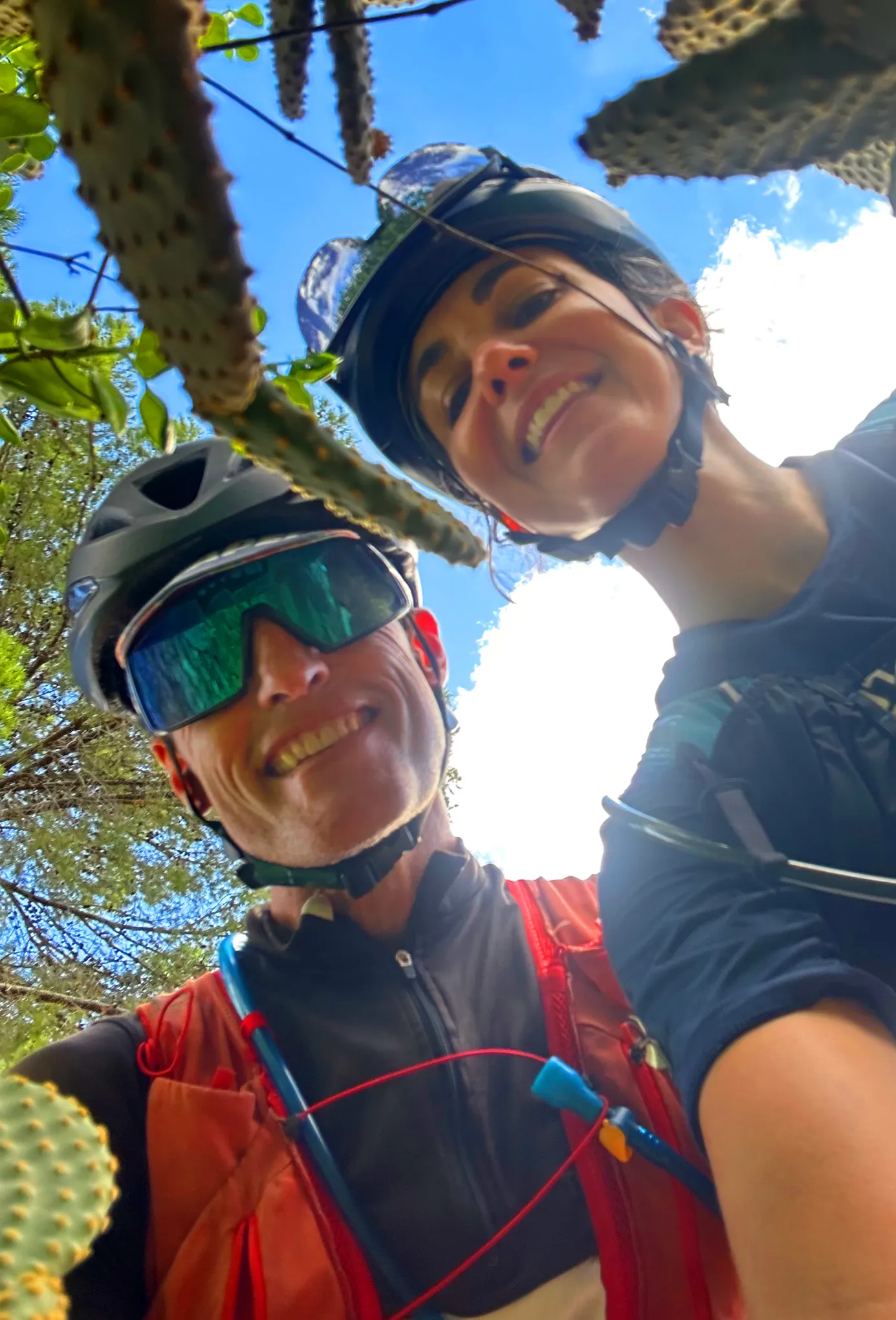 Wild Skies Adventures founders Steph van Gelderen and Grant Clark smiling together on a mountain bike ride